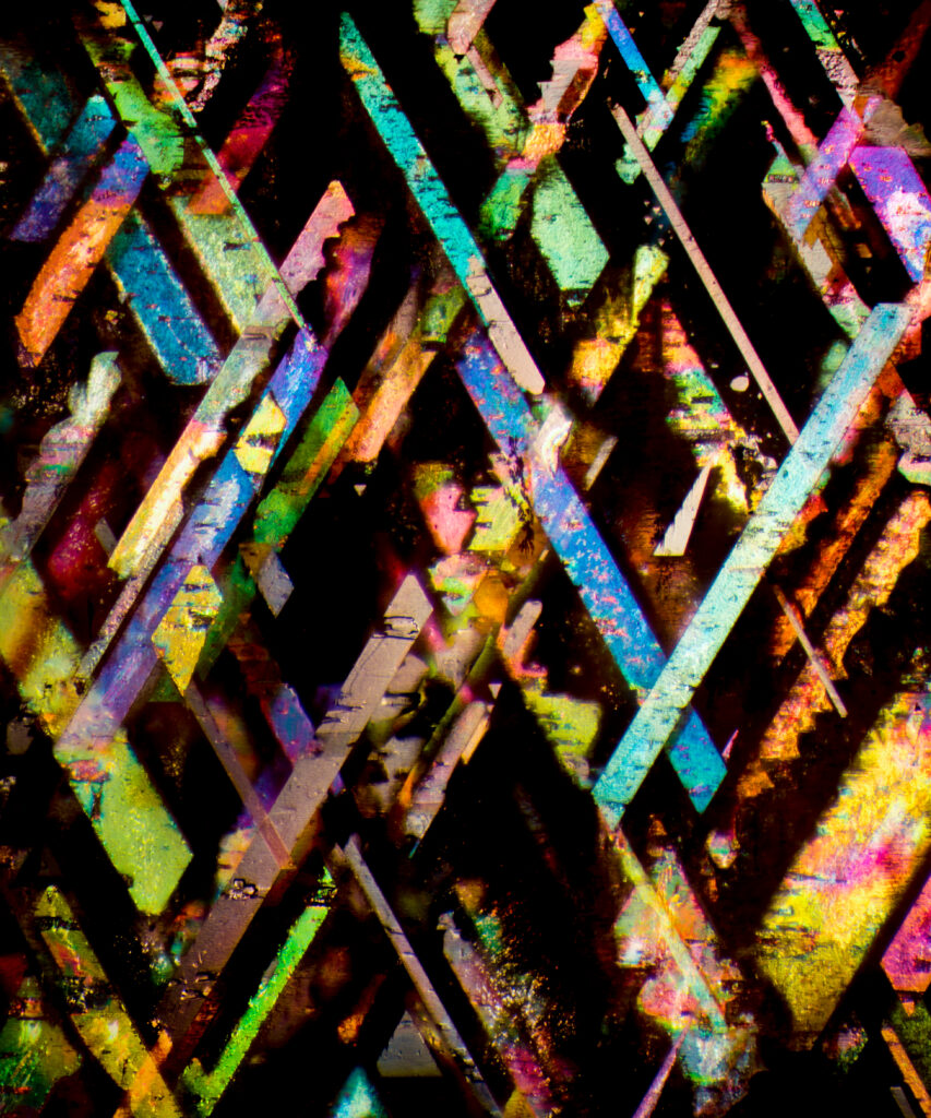 Microscopic inclusions in a rainbow lattice sunstone.
